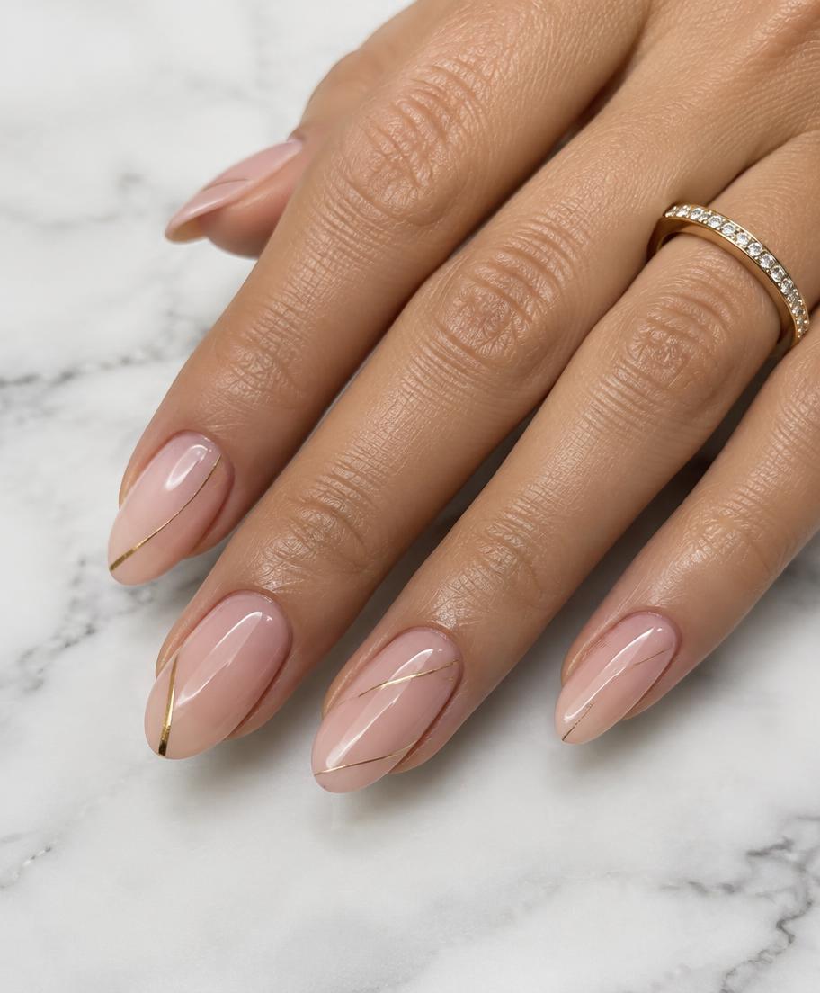 Blush nails with fine gold line nail art